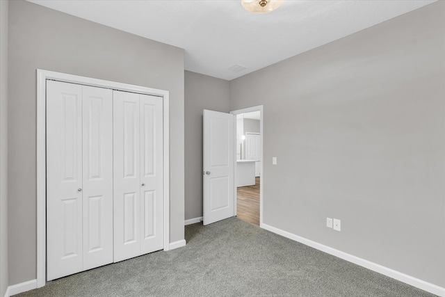 unfurnished bedroom featuring carpet floors and a closet