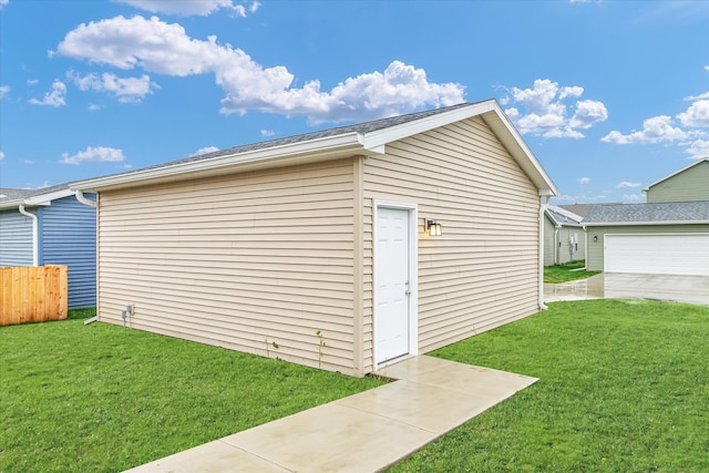 view of outbuilding with a lawn and a garage