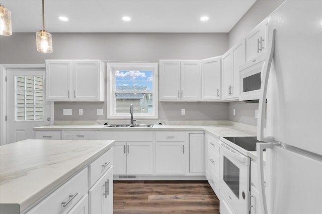 kitchen with white cabinets, white appliances, decorative light fixtures, and sink