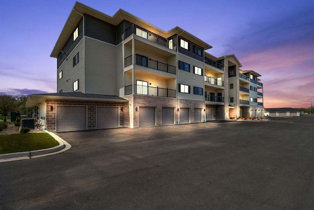 outdoor building at dusk featuring a garage