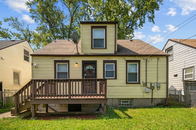 back of house featuring a wooden deck and a lawn