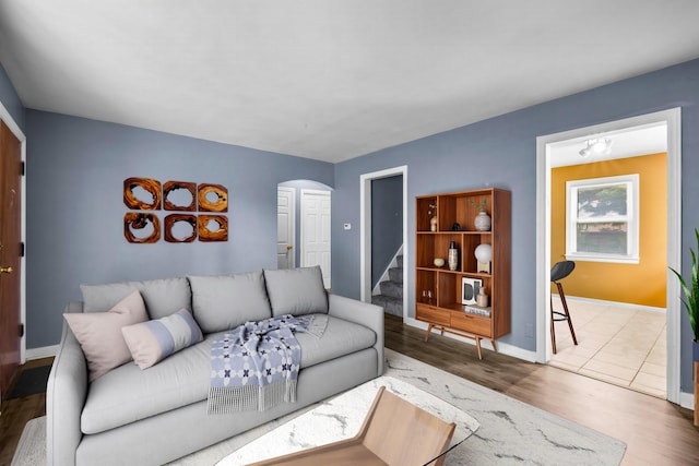12233 S Morgan St, Chicago, IL 60643 - living room featuring arched walkways, wood finished floors, stairway, and baseboards