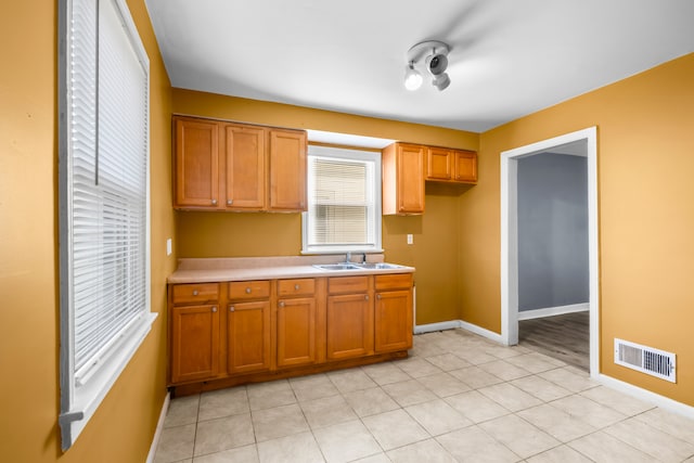 kitchen with light tile patterned floors and sink