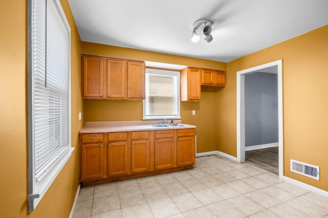 12233 S Morgan St, Chicago, IL 60643 - kitchen featuring a sink, baseboards, brown cabinets, and light countertops