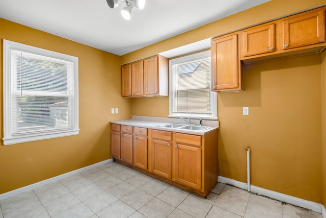 kitchen featuring light tile patterned flooring and sink