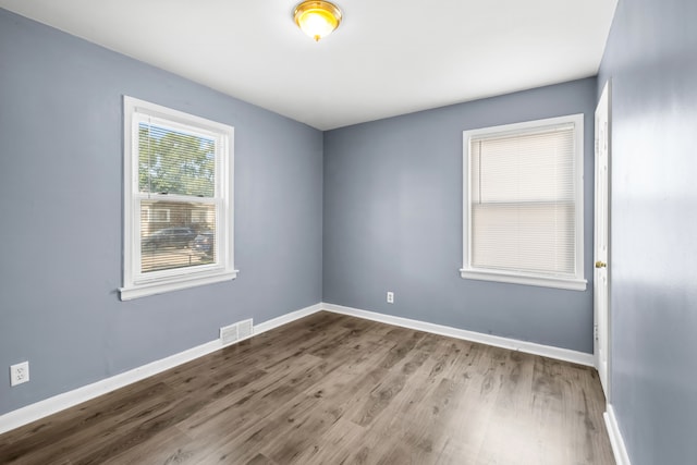 unfurnished room with hardwood / wood-style floors