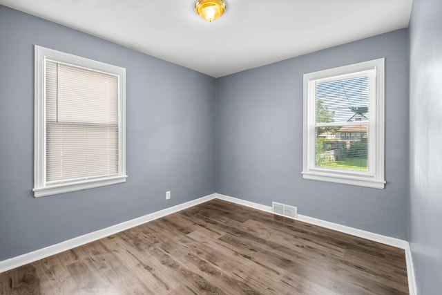 unfurnished room featuring wood-type flooring