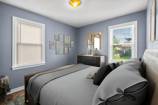 bedroom with dark wood-type flooring