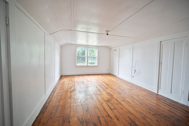 bonus room featuring vaulted ceiling and hardwood / wood-style floors