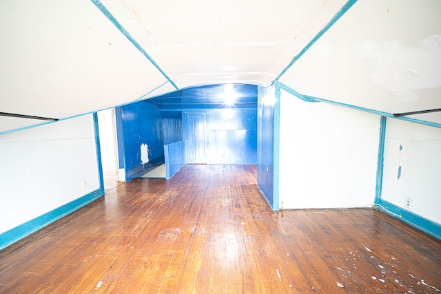 additional living space featuring lofted ceiling and wood-type flooring