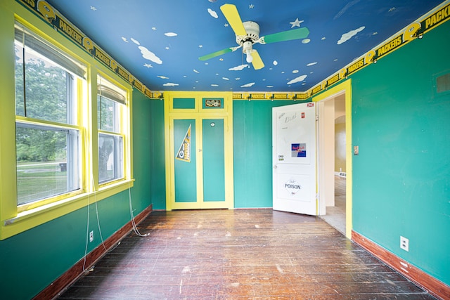 empty room featuring ceiling fan and wood-type flooring