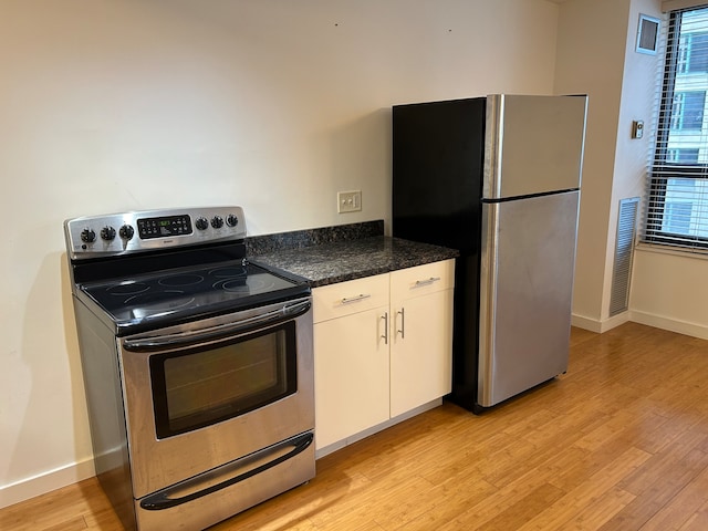 kitchen featuring light hardwood / wood-style flooring, stainless steel appliances, and white cabinetry