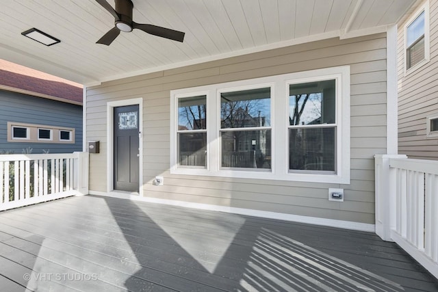 wooden terrace featuring ceiling fan