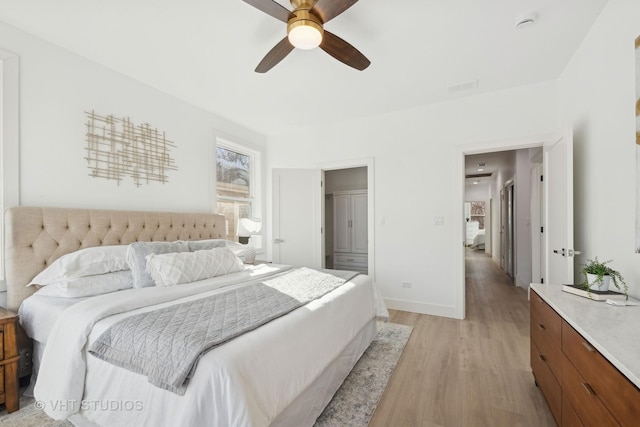 bedroom featuring light hardwood / wood-style flooring and ceiling fan