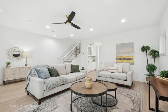 living room with ceiling fan and light wood-type flooring