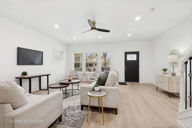 living room with ceiling fan and light hardwood / wood-style floors