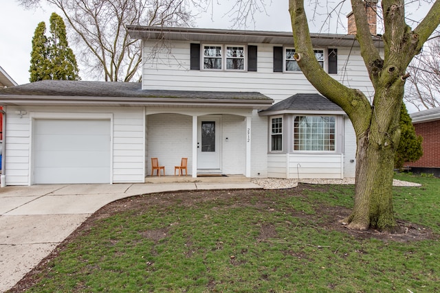 view of front of property with a front lawn and a garage