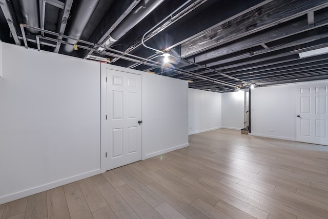 basement featuring light hardwood / wood-style flooring