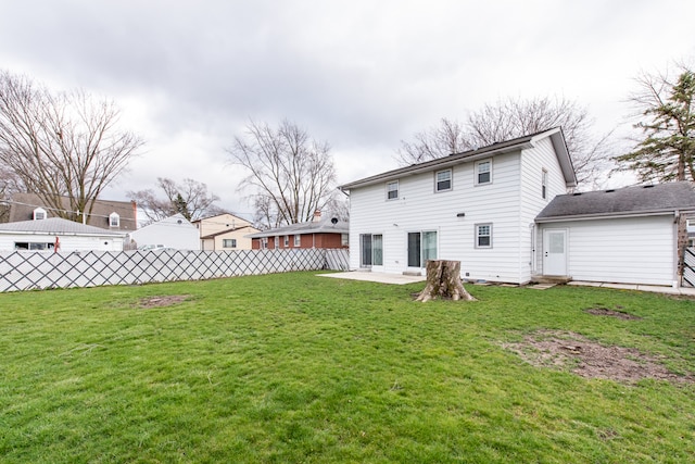 rear view of house featuring a patio and a yard