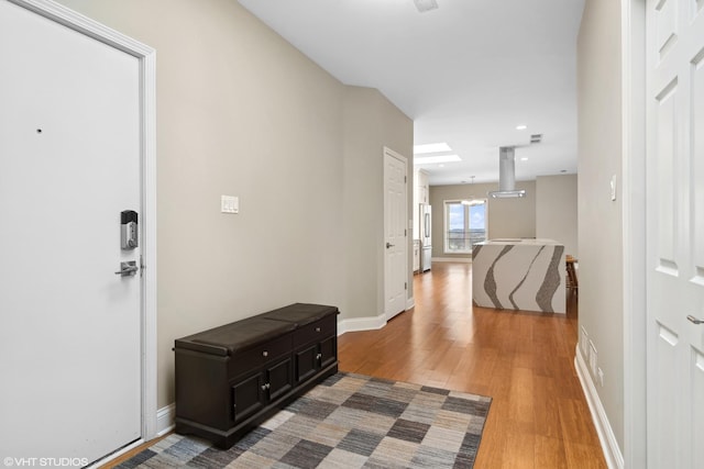 hallway featuring a chandelier and hardwood / wood-style flooring