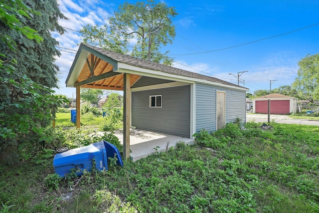 view of side of home featuring an outbuilding