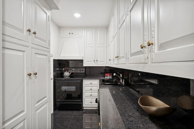 kitchen with white cabinets, tasteful backsplash, sink, and black range with electric stovetop