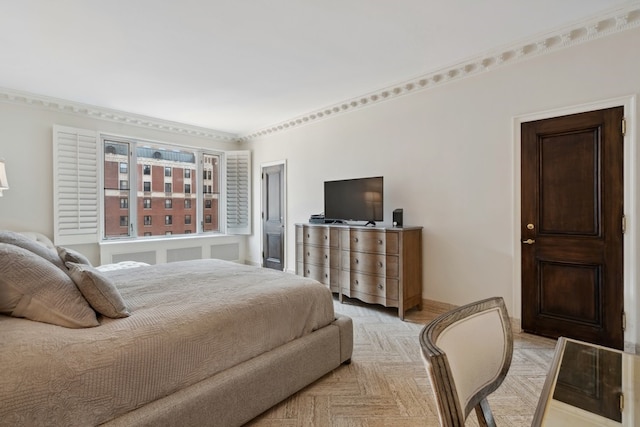 bedroom with crown molding and light parquet flooring