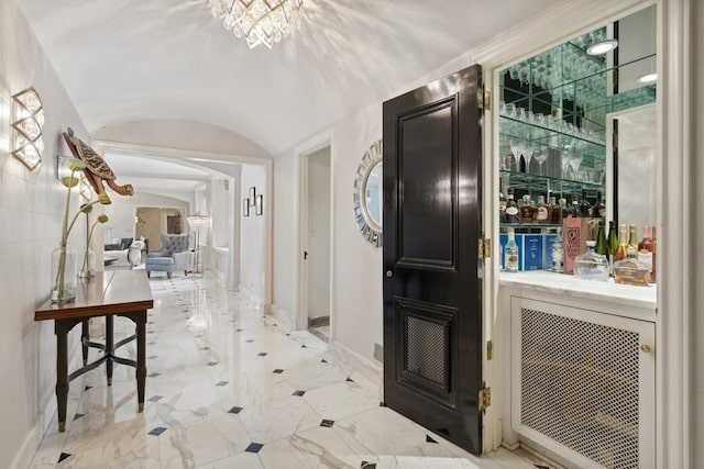 corridor featuring tile walls and light tile floors