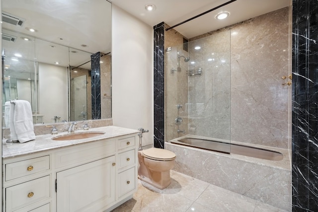 full bathroom with tiled shower / bath combo, tile flooring, vanity, and toilet