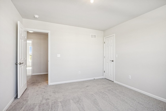 unfurnished room with light carpet