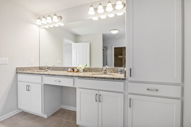 bathroom featuring a shower with shower door, tile patterned flooring, and vanity