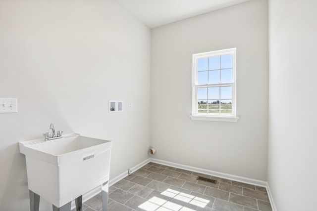 washroom with hookup for a washing machine and sink