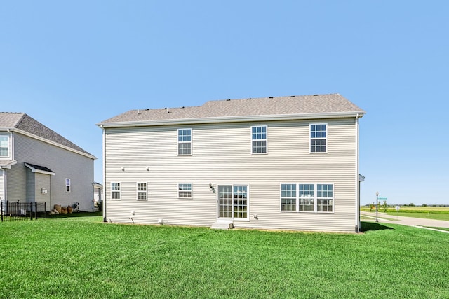 back of property featuring a lawn