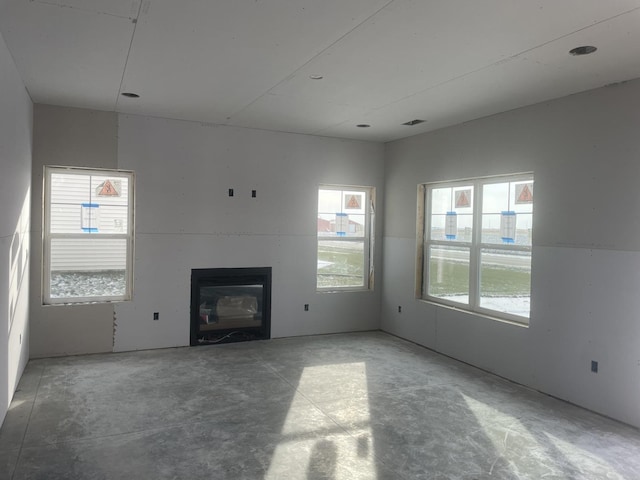 unfurnished living room featuring concrete floors