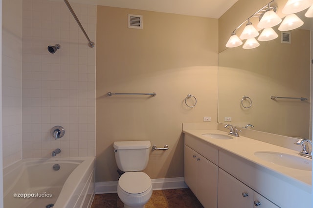 full bathroom featuring tiled shower / bath combo, tile floors, toilet, and dual vanity