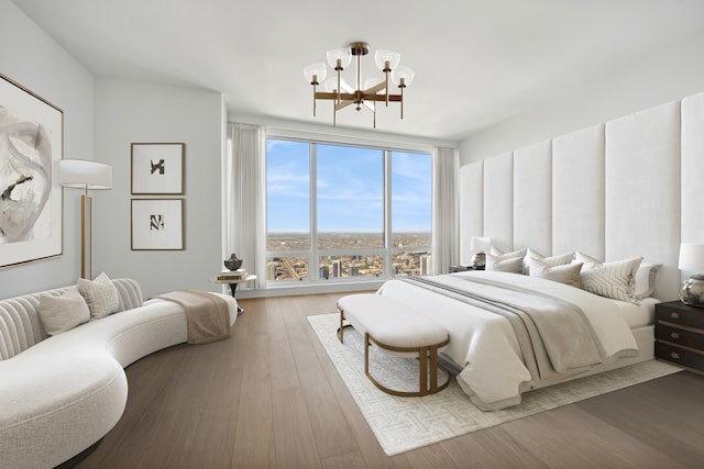 bedroom with a notable chandelier and hardwood / wood-style flooring