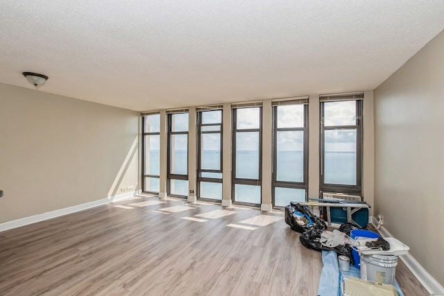 empty room with hardwood / wood-style flooring and a textured ceiling