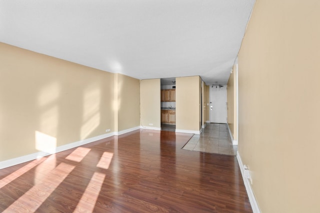 unfurnished room with dark hardwood / wood-style flooring