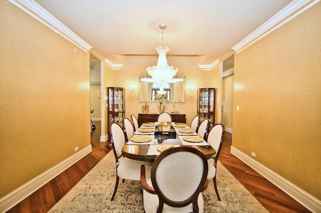 dining area with a chandelier, dark wood-type flooring, and ornamental molding