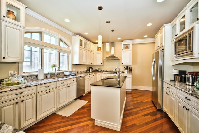 kitchen with sink, wall chimney range hood, dark hardwood / wood-style floors, a kitchen island with sink, and appliances with stainless steel finishes