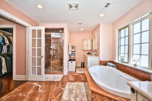 bathroom with vanity and separate shower and tub