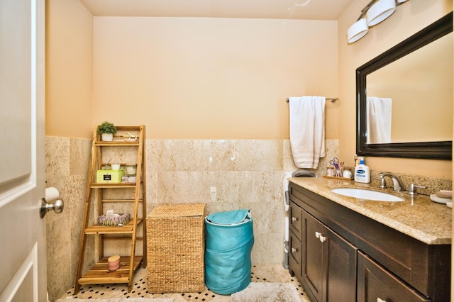 bathroom featuring vanity, tile patterned floors, and tile walls