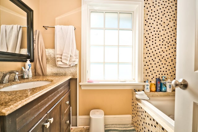 bathroom with vanity and tiled bath