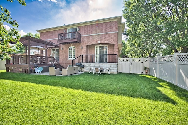 rear view of house featuring a pergola, outdoor lounge area, a balcony, and a lawn