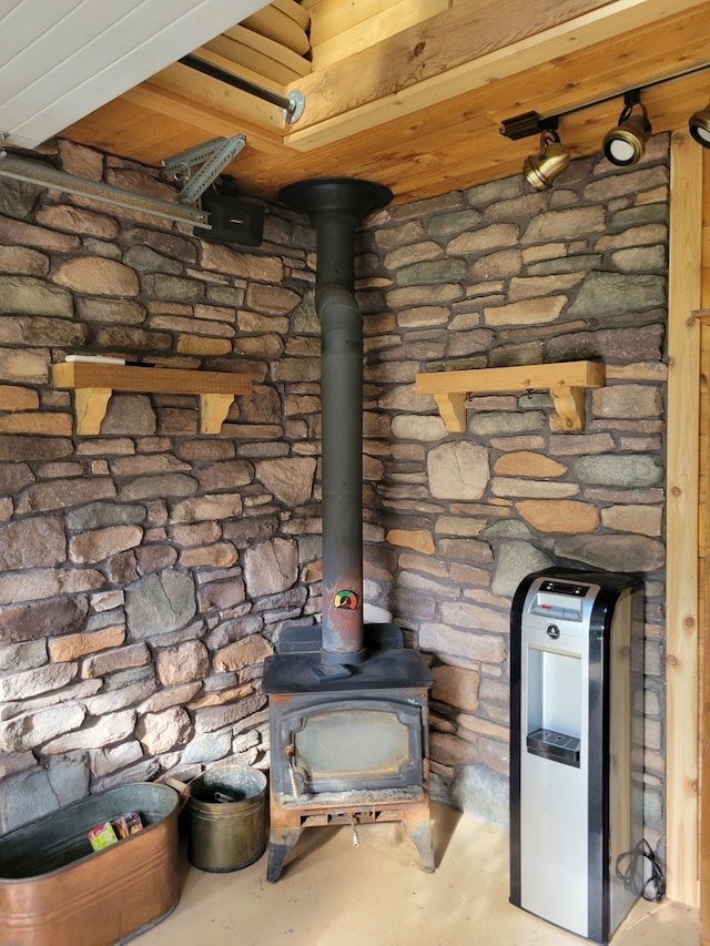 room details featuring concrete floors and a wood stove