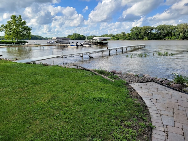 dock area with a water view and a yard