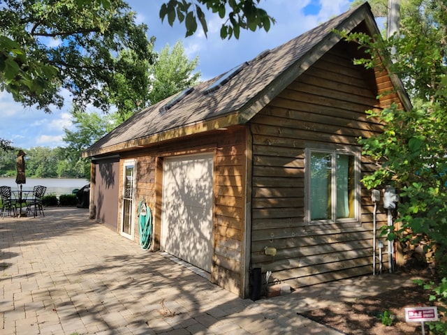 exterior space with a garage and a patio