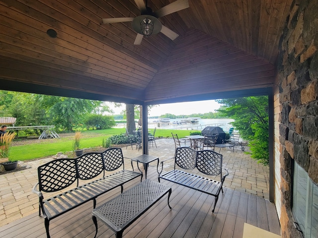 wooden deck featuring ceiling fan and a patio