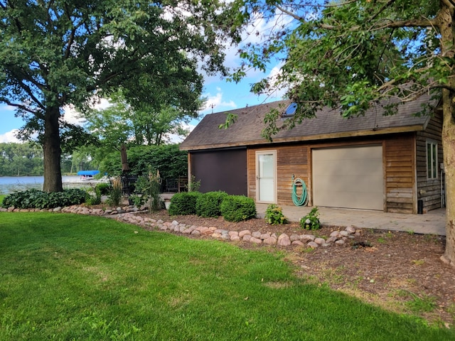 exterior space featuring a garage and a yard