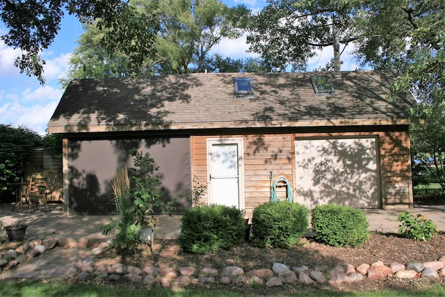 exterior space with a garage and an outdoor structure